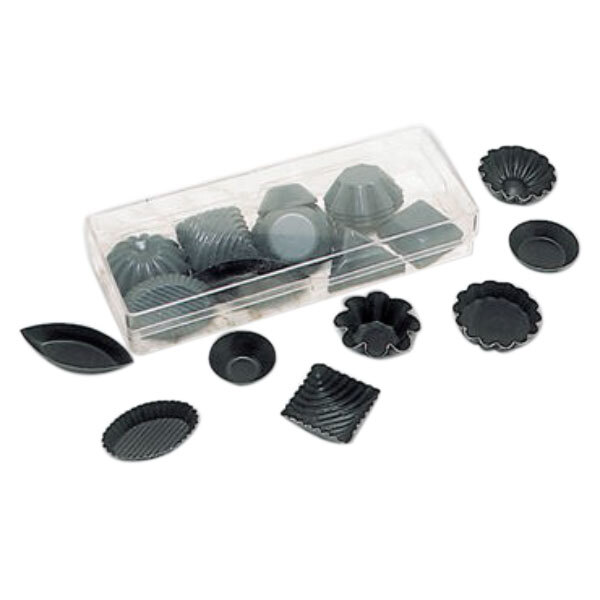 A plastic container with black Matfer Bourgeat quiche, tartlet, and petit four molds.