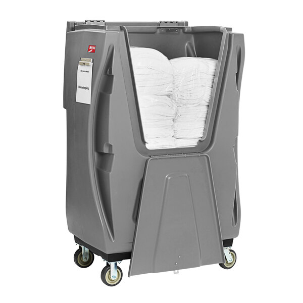 A large grey MetroTrux container with white towels inside.