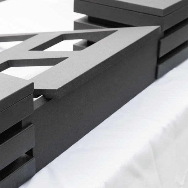 A black rectangular Vollrath wood crossbar.