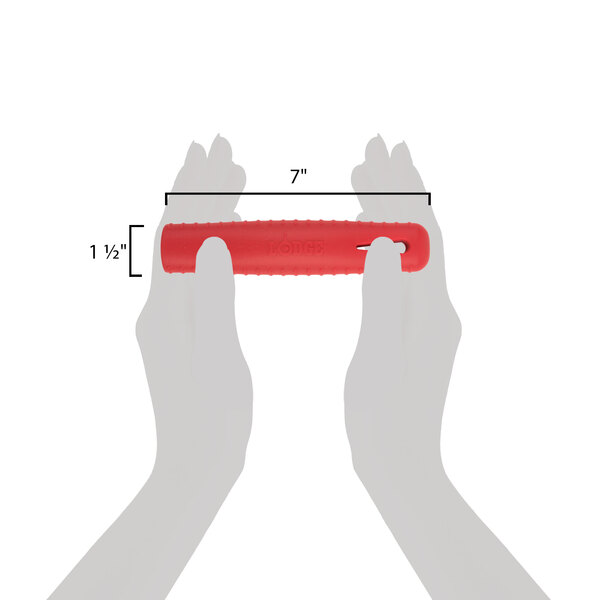 A white hand using a Lodge red silicone handle holder on a red skillet handle.