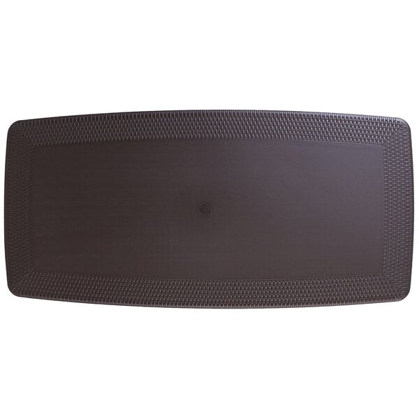 A brown plastic folding table set with chairs on a black surface.