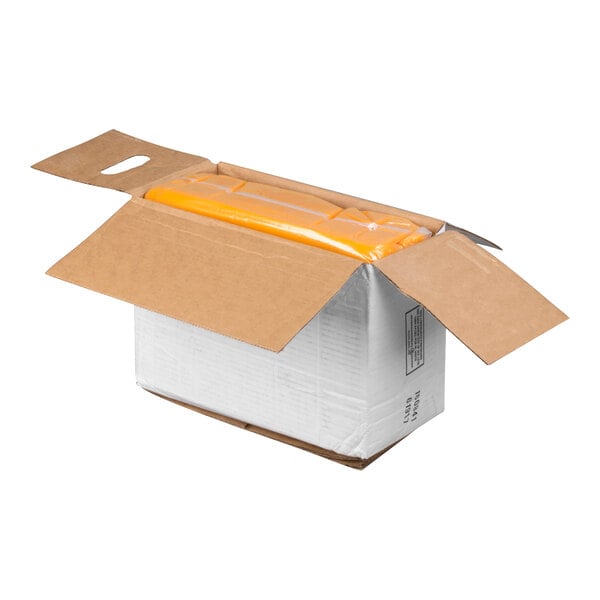 An open cardboard box containing a large yellow bag sealed in plastic.