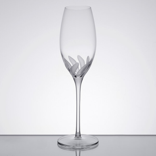 A Libbey Bloom champagne flute with a leaf design on it.