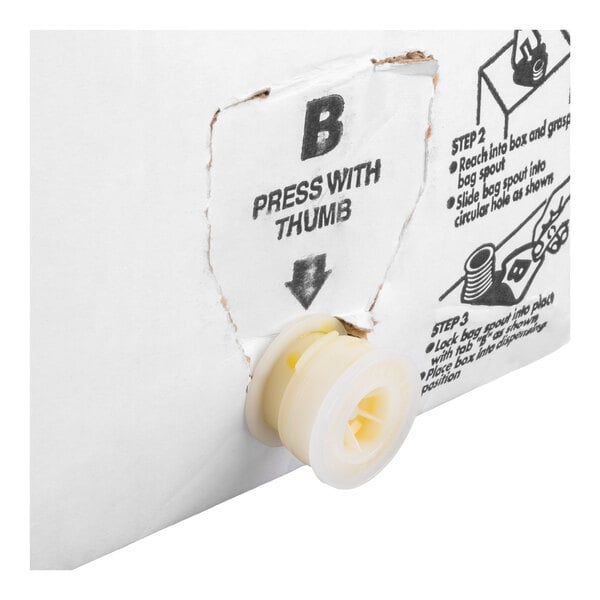 A close-up of a white cardboard box with a plastic spout protruding from a perforated opening, accompanied by printed instructions.