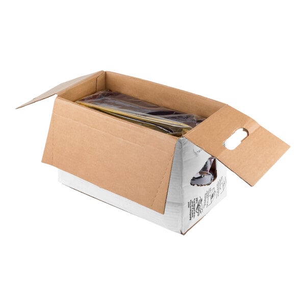An open cardboard box with flaps spread out, containing a sealed plastic bag filled with a yellow liquid.