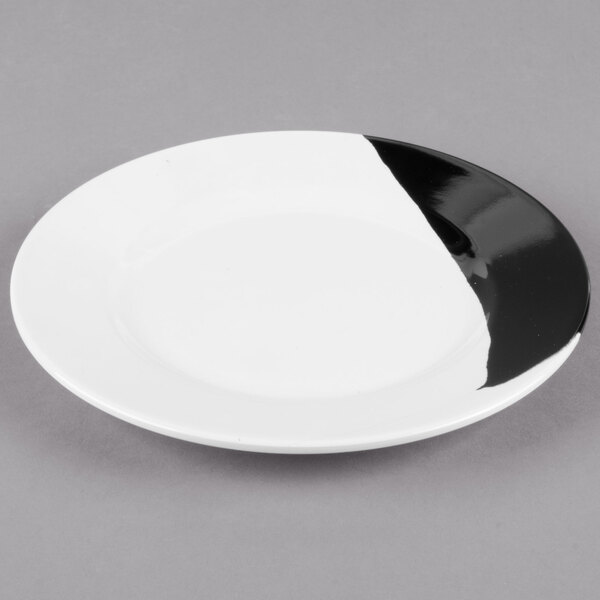 A white melamine plate with a wide black rim.