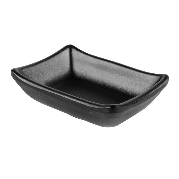 A black rectangular GET Nara melamine sauce dish with a rounded edge.