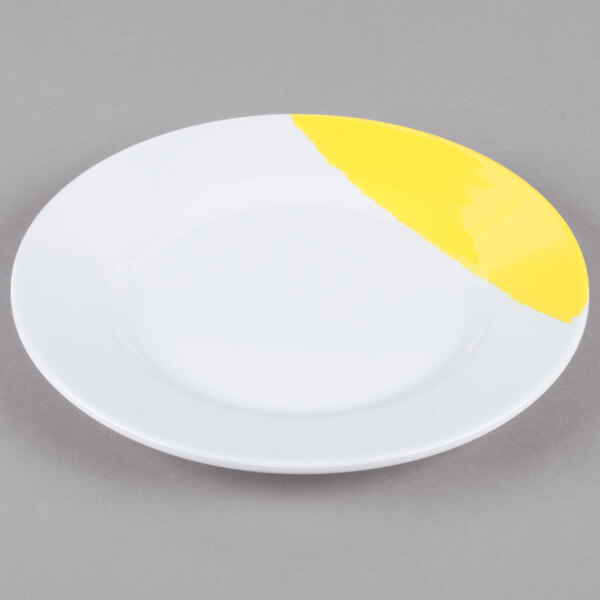 A white melamine plate with a wide yellow rim.