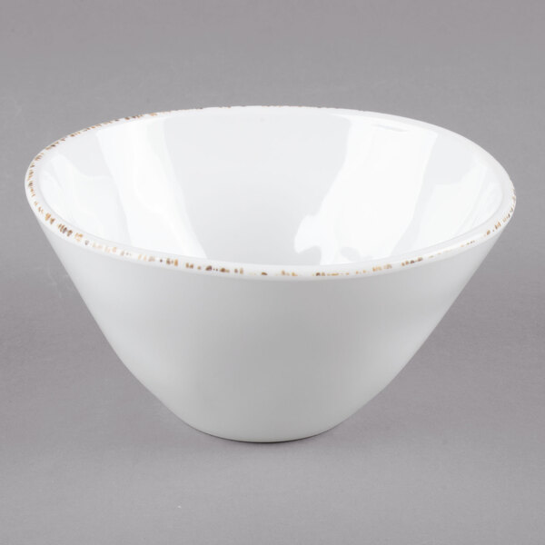 A white bowl with brown specks.