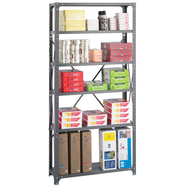 A Safco dark gray metal shelving unit with many boxes and papers on the shelves.