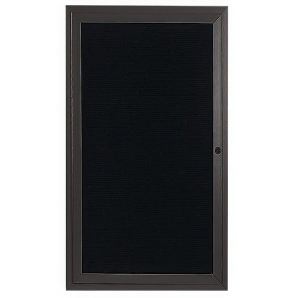 A black rectangular door with a black frame containing a black letter board.