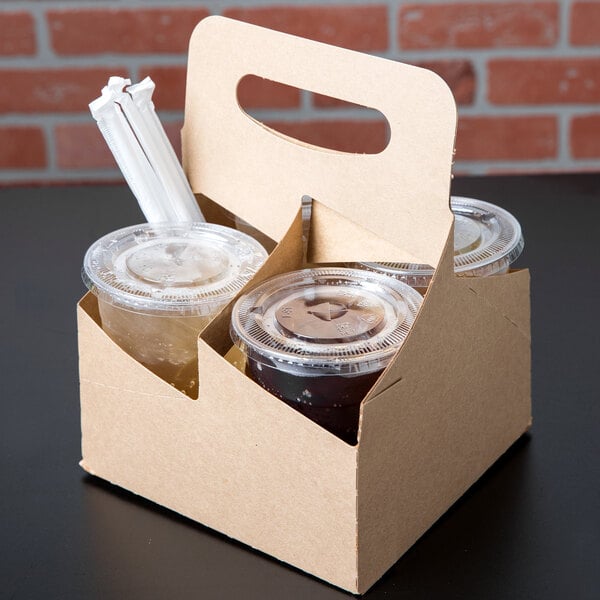 A 4 Cup Kraft Pop-Up drink carrier with two cups of liquid in it.