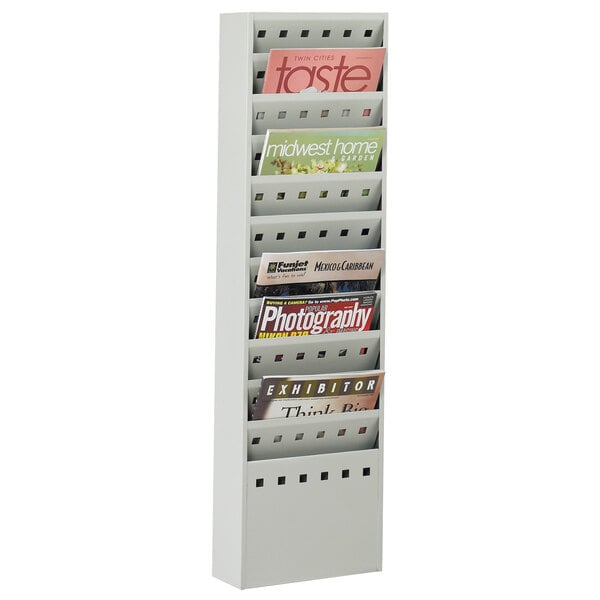 A gray Safco steel magazine display rack with several magazines on it.