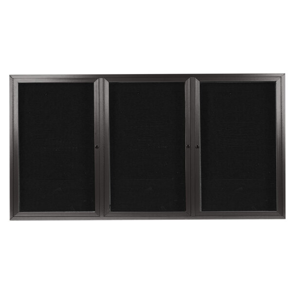 A black rectangular Aarco outdoor directory board with a bronze metal frame and three black doors with glass panels.