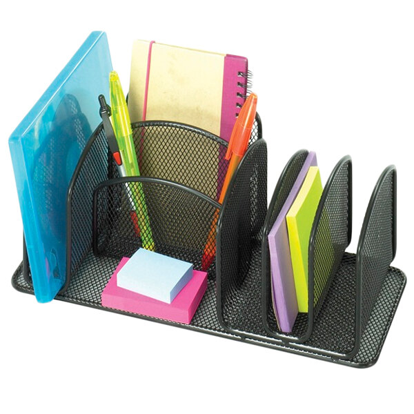 A black metal Safco desk organizer with compartments holding pens, pencils, and sticky notes.