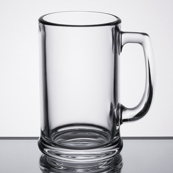 A Libbey clear glass beer mug with a handle.