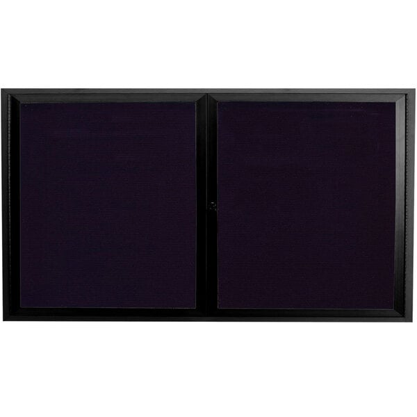 A black rectangular directory board with two black framed glass doors.