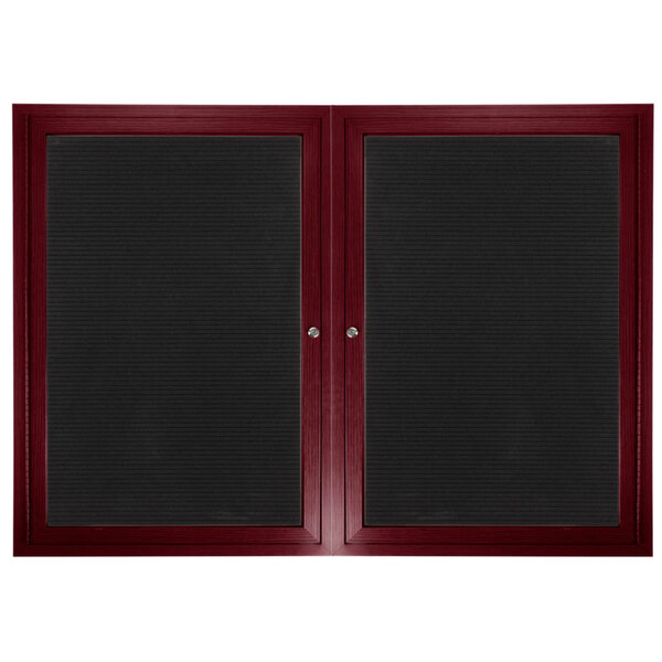 A black board with a red frame and two black glass doors.