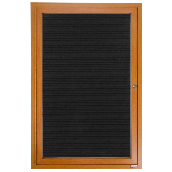 An Aarco enclosed oak directory board with a black felt rear panel and black frame on the door.