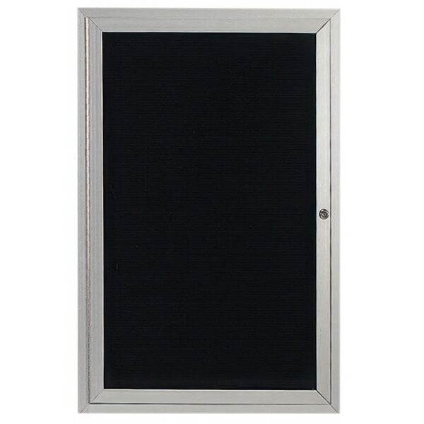 A black board with a silver frame behind a hinged glass door.