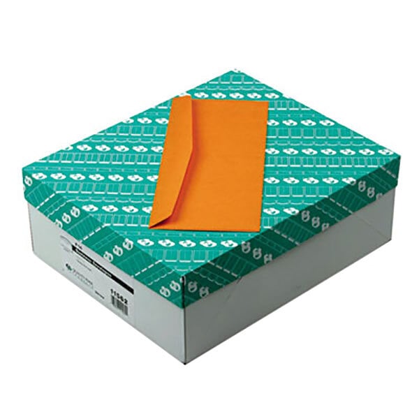 A box with a Quality Park brown Kraft business envelope on it.