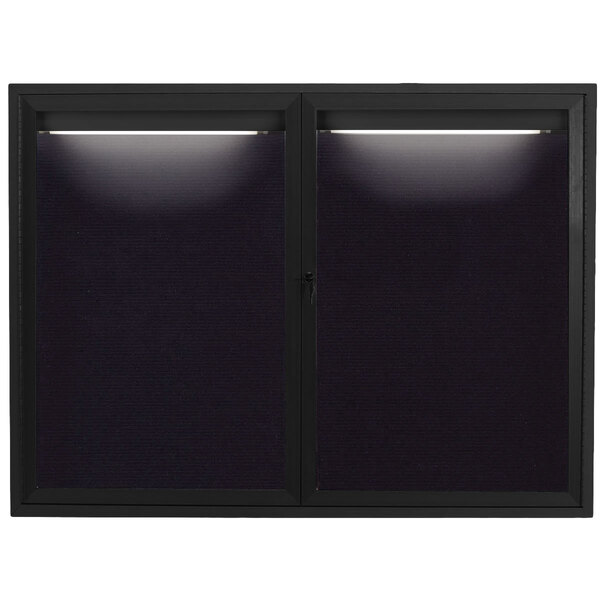 A black rectangular Aarco message center with two lights on it.