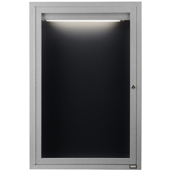 A black rectangular message center with a light on the door.