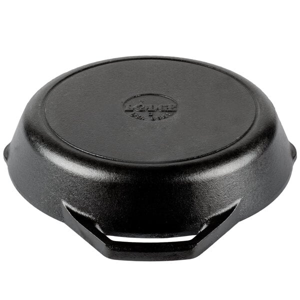 A black cast iron skillet with dual handles on a kitchen counter.