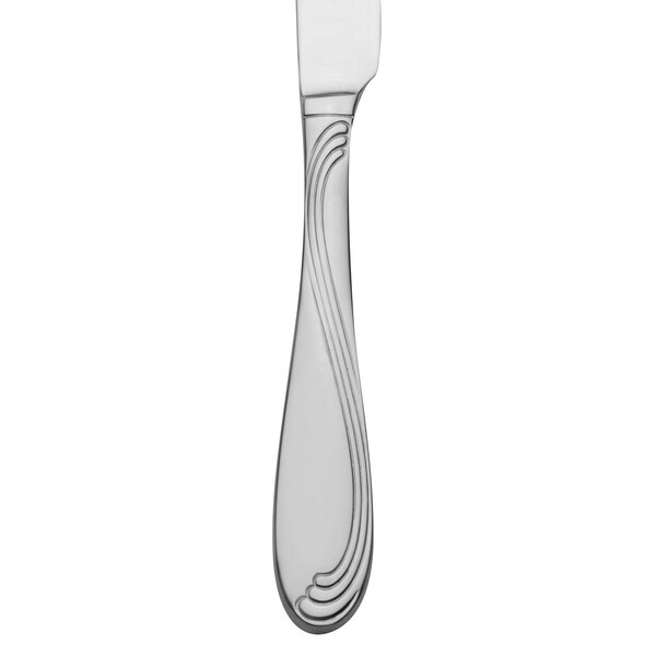A silver Oneida dinner knife with a scroll design on the handle.