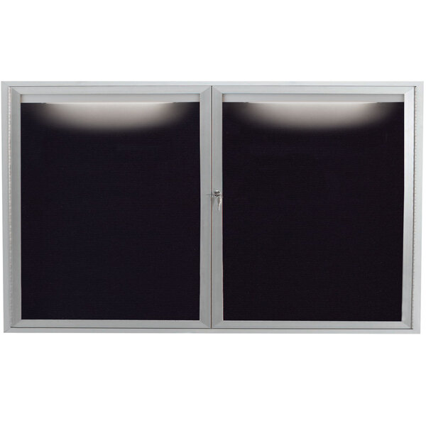 An Aarco black and white outdoor message center with a lighted window.