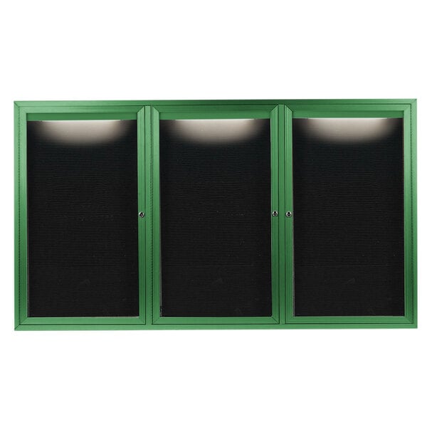 A green cabinet with black doors and a black letter board inside.