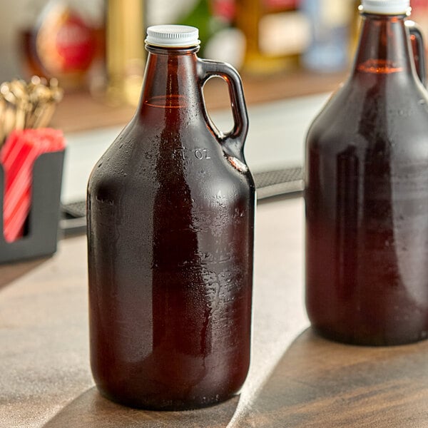 Two Libbey amber glass growlers on a table.