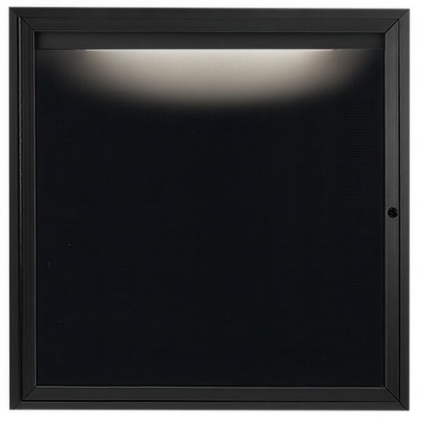 A black square frame with a hinged door and a light on it.