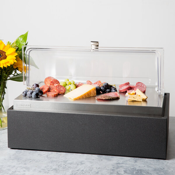A Vollrath display case with food on a counter.