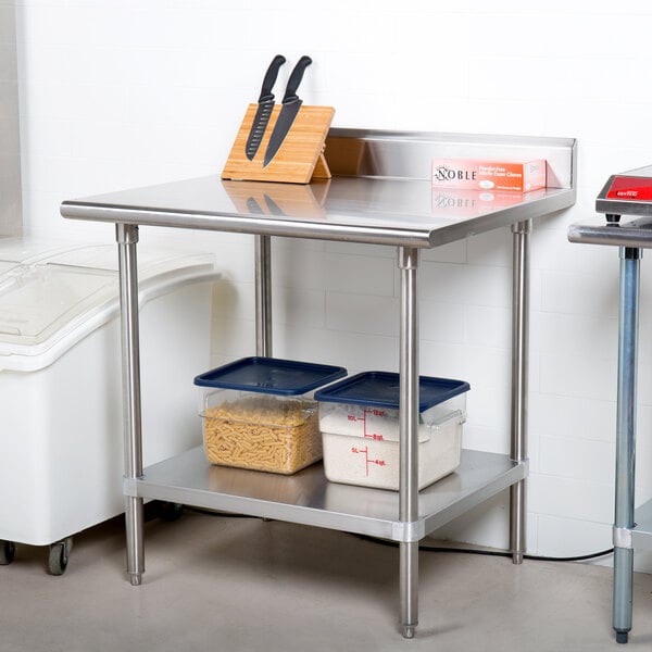 An Advance Tabco stainless steel work table with a stainless steel undershelf.