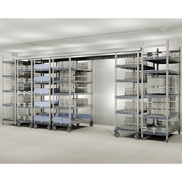 A large metal shelving system with multiple racks and wire baskets on wheels, designed for organized storage.