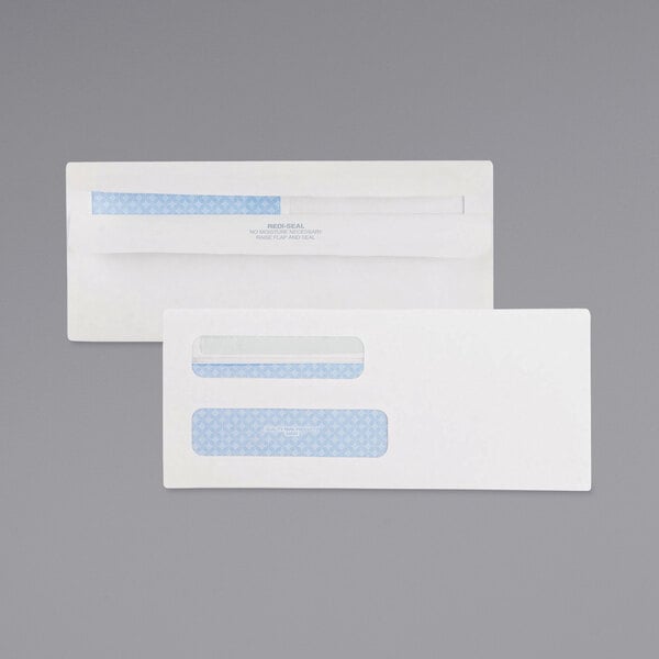 A white Quality Park business envelope with blue and white rectangular labels over the windows.