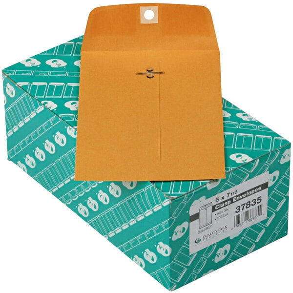 A box with a brown Quality Park file envelope on top.