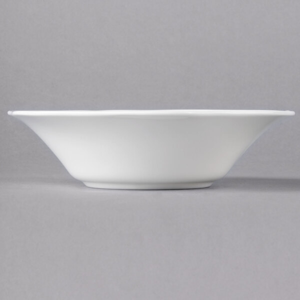 A close up of a Villeroy & Boch white bone porcelain deep plate with a floral design.