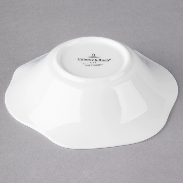 A Villeroy & Boch white bone porcelain deep plate with a small white design on it.