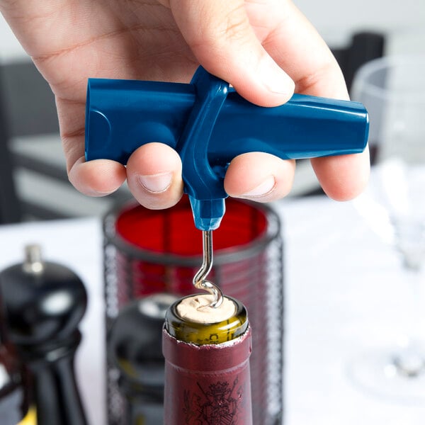 A person holding a Franmara dark blue plastic corkscrew and bottle opener.