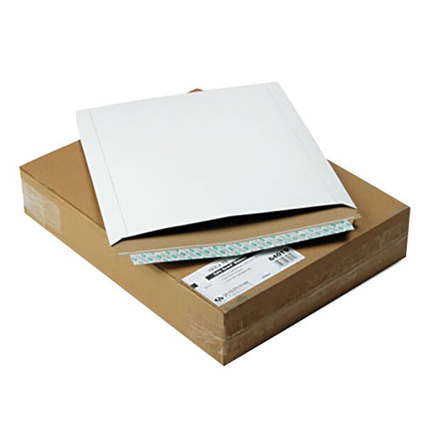 A cardboard box with a white envelope on top.