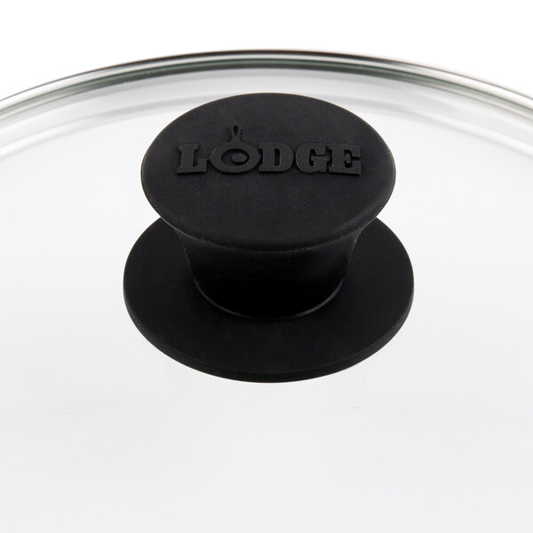 A Lodge tempered glass lid with a black knob on top.