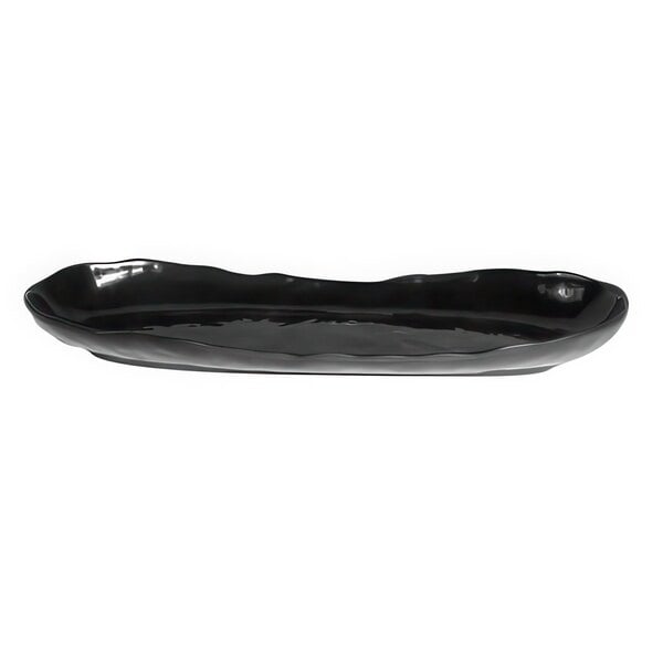 An Elite Global Solutions black melamine oval tray with uneven edges.