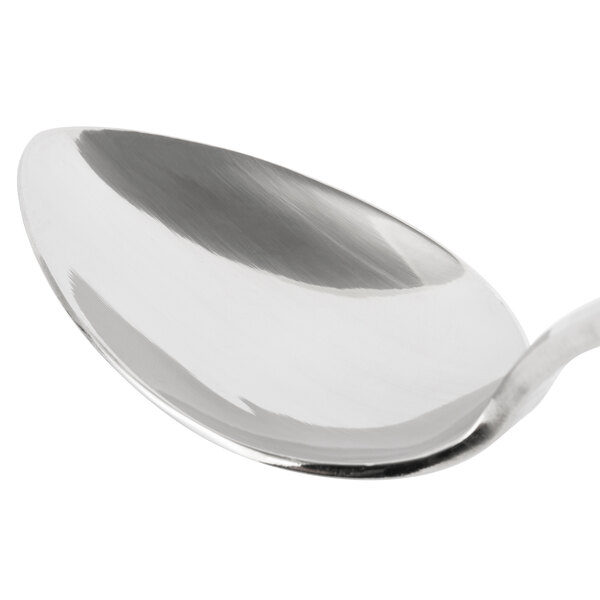 A close-up of a Bon Chef Reflections spoon with a silver handle.