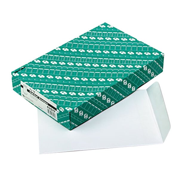 A green box with white designs and white paper envelopes.