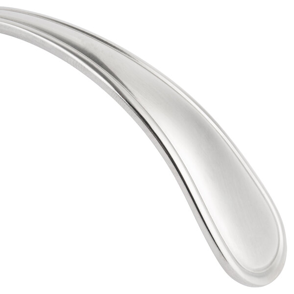 A close-up of a Bon Chef Tuscany silver bouillon spoon with a curved handle.