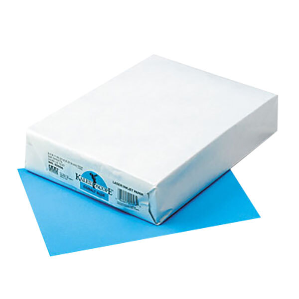 A white package of Pacon Kaleidoscope cobalt blue multi-purpose paper on a blue surface.