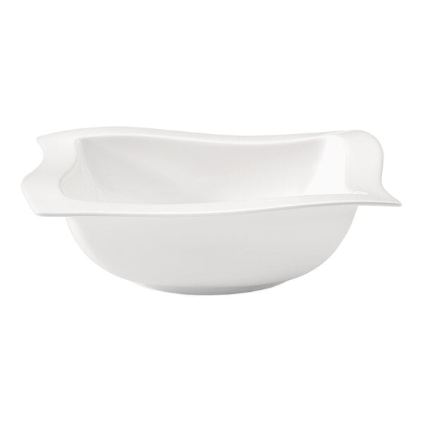 A Villeroy & Boch white porcelain salad bowl with a wavy edge.