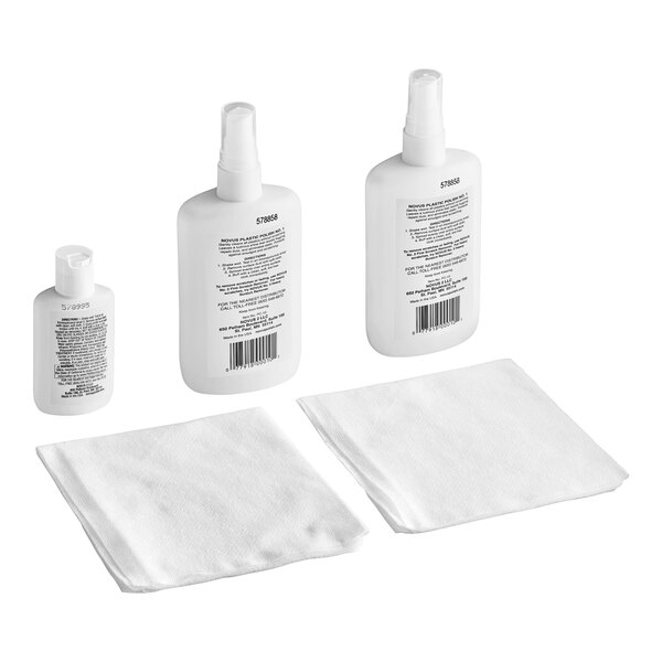 A white plastic bottle of Novus Acrylic Cleaning Kit with a white label and a pump next to a white cloth.